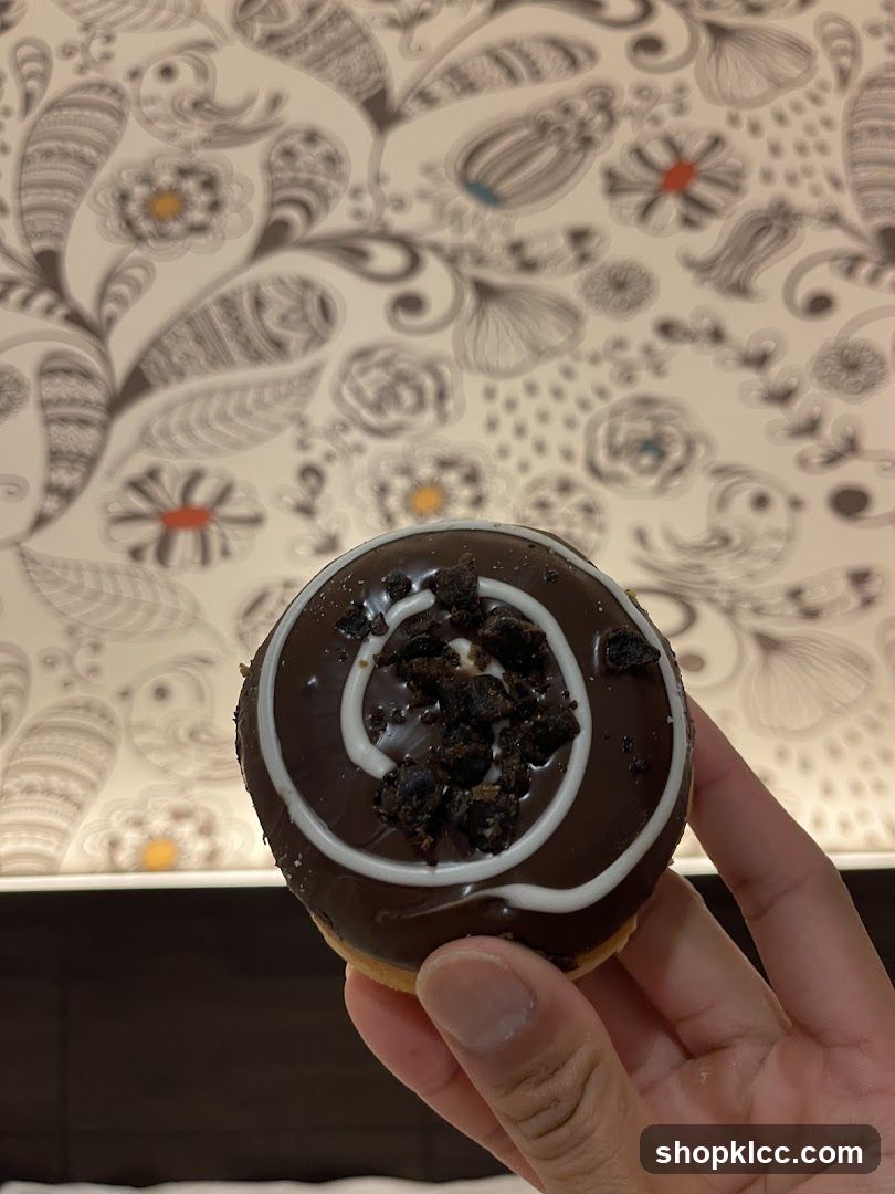 Chocolate Donut with White Swirls and Crumbs