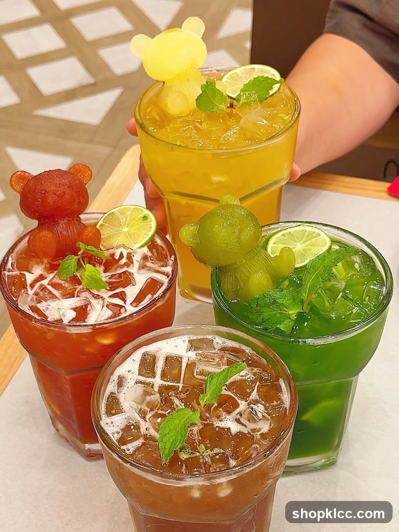 Four colorful drinks with bear-shaped ice cubes