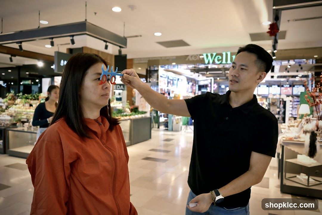Man holding a colorful object near woman's face in mall