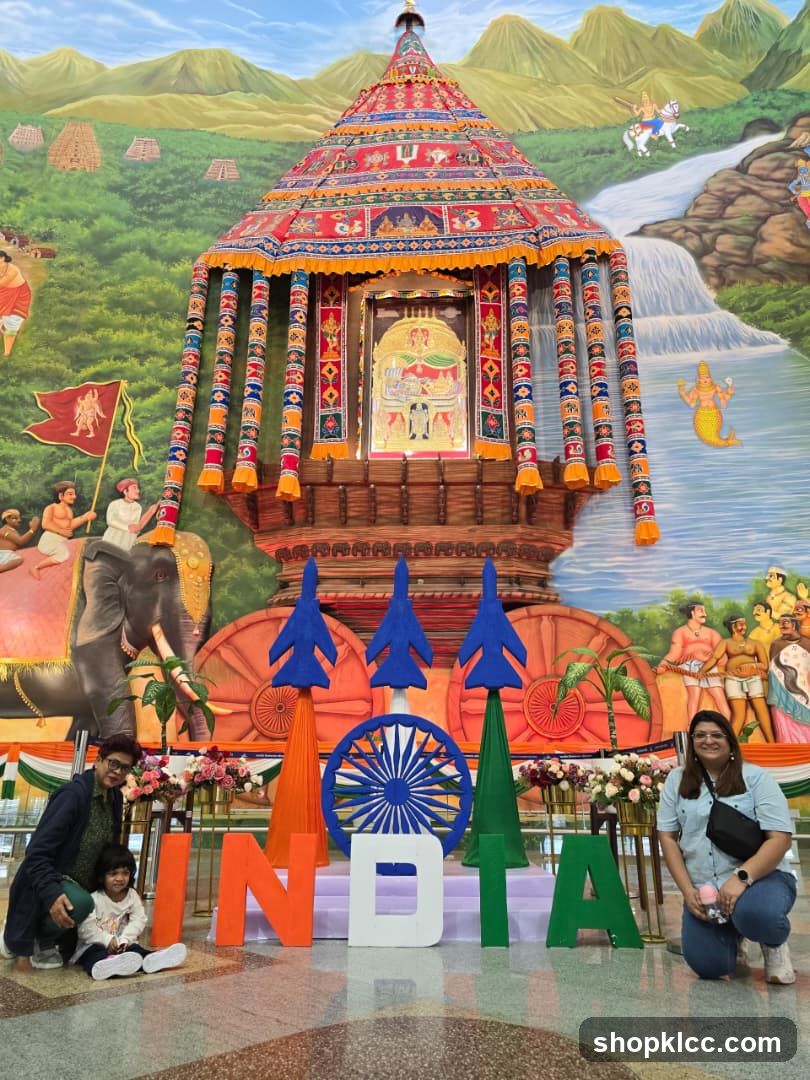 People Posing with INDIA Letters and Mural