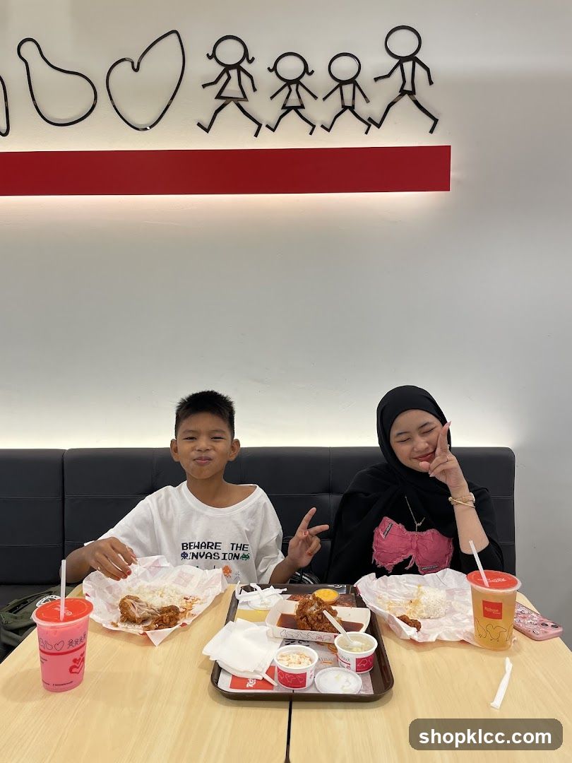 Two people eating fried chicken