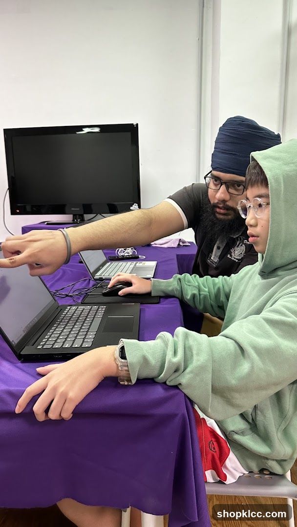 Two people looking at a laptop