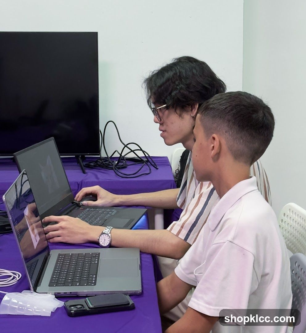 Two people working on laptops