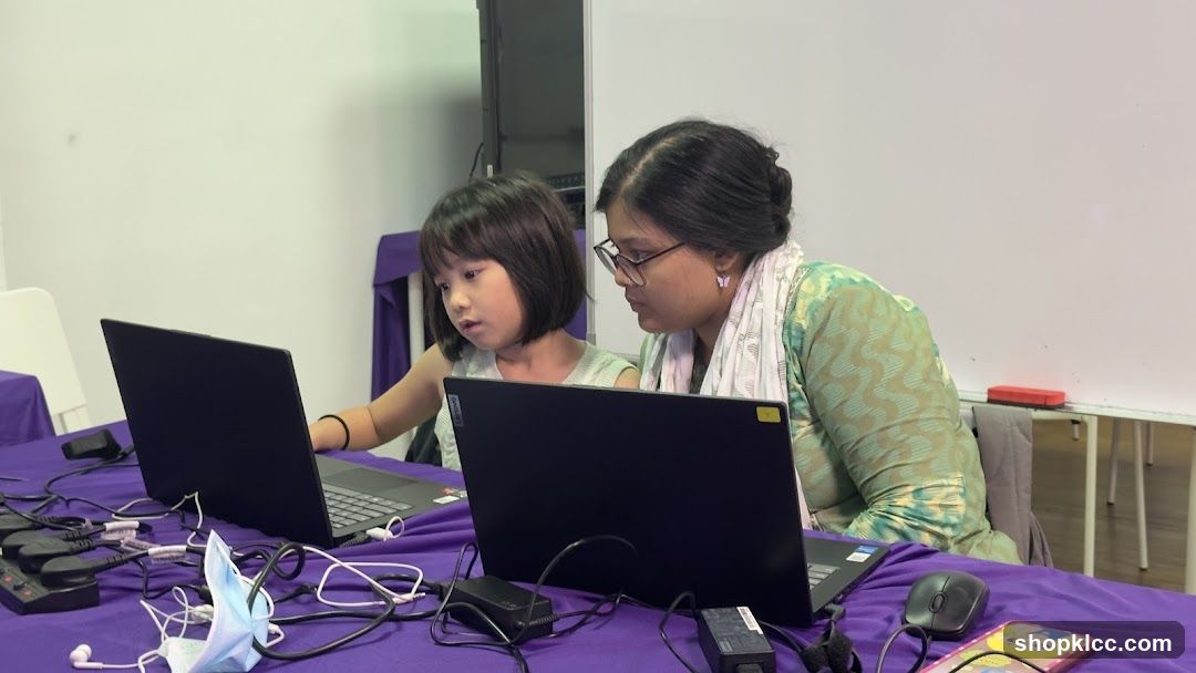Woman and child using laptops