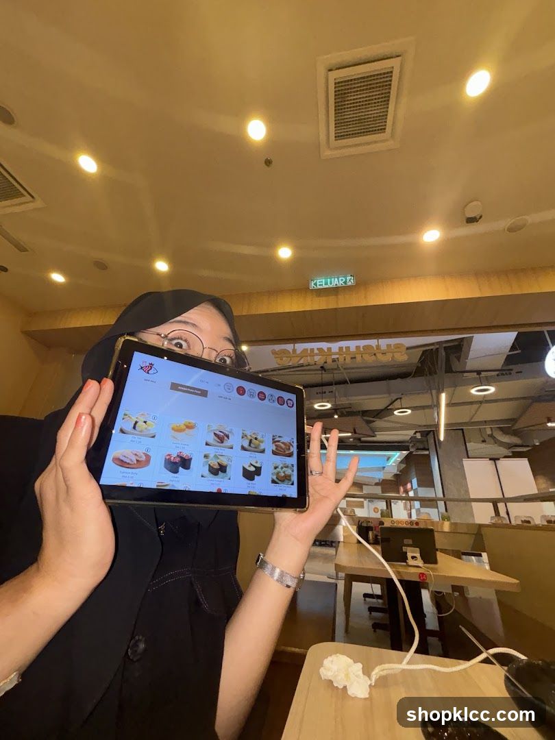 Person holding a tablet menu in a restaurant
