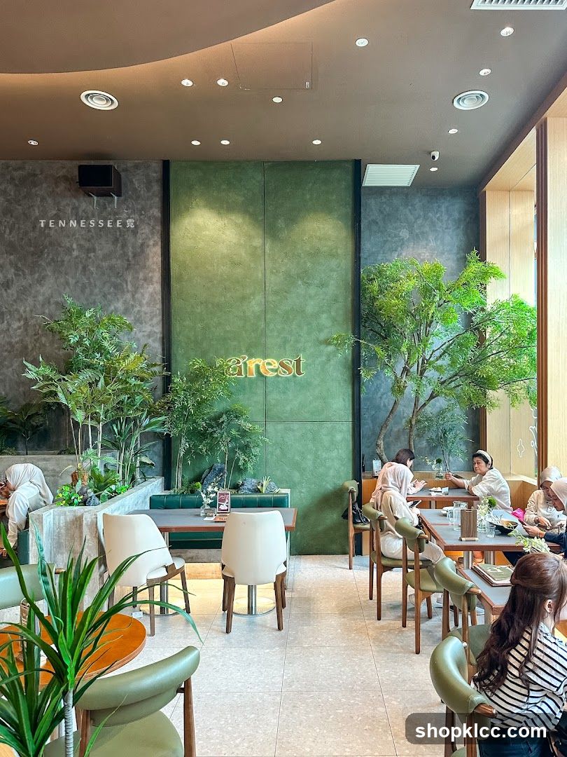 Interior of a cafe with green accents and plants