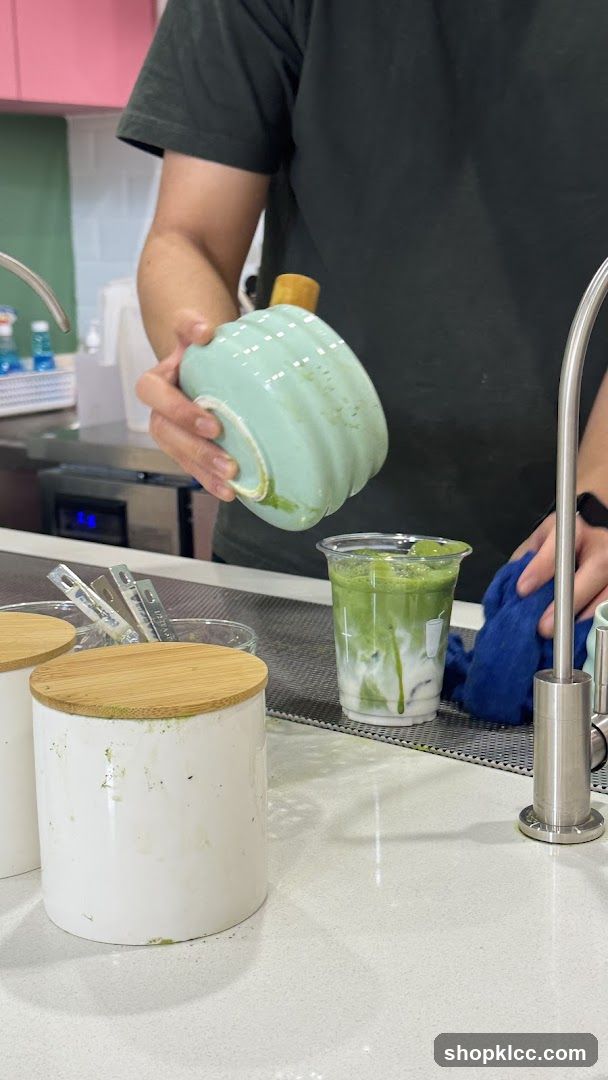 Barista preparing a matcha drink