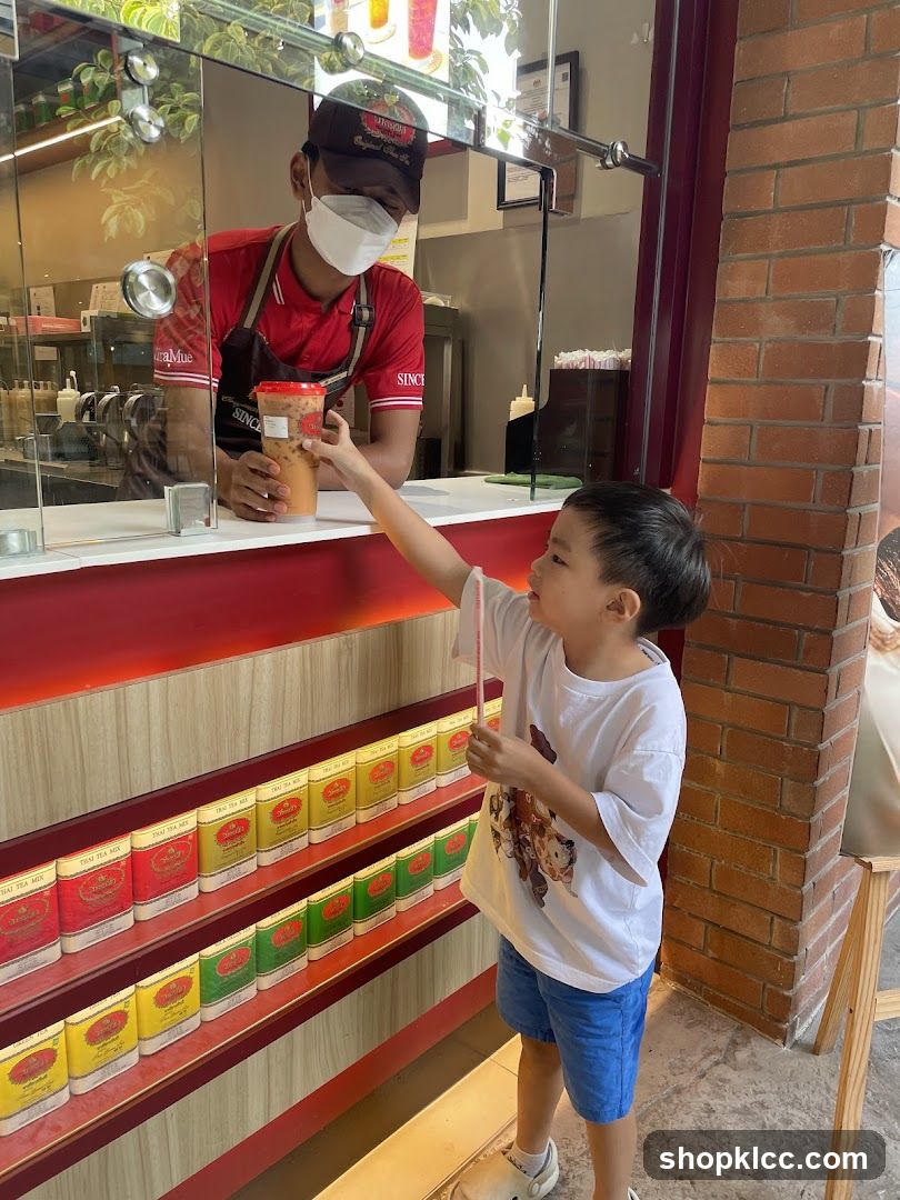 Customer receiving drink from staff