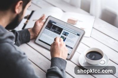 Person Using Tablet at Table with Coffee