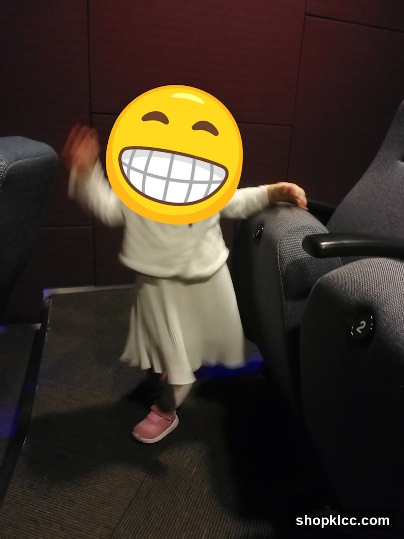 Child in Theater Seats