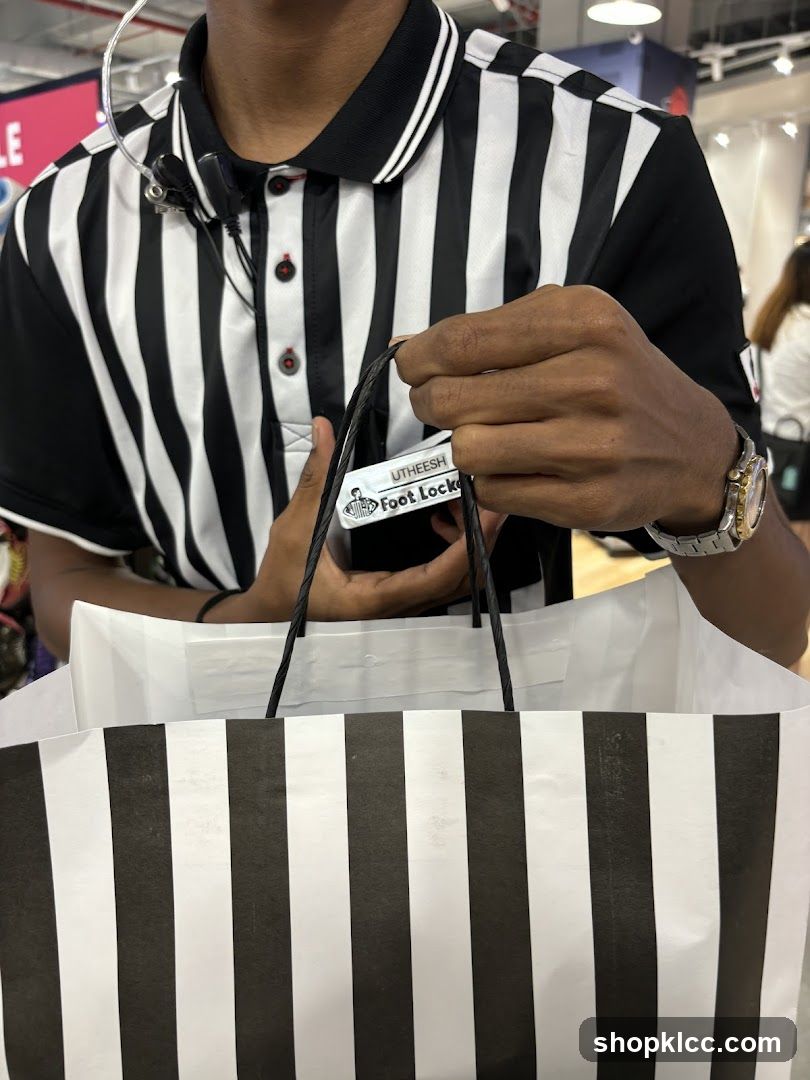 Foot Locker employee with shopping bag