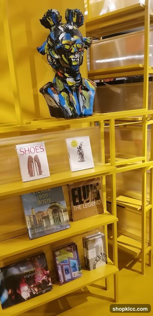 Yellow Bookshelf Display with Artistic Bust