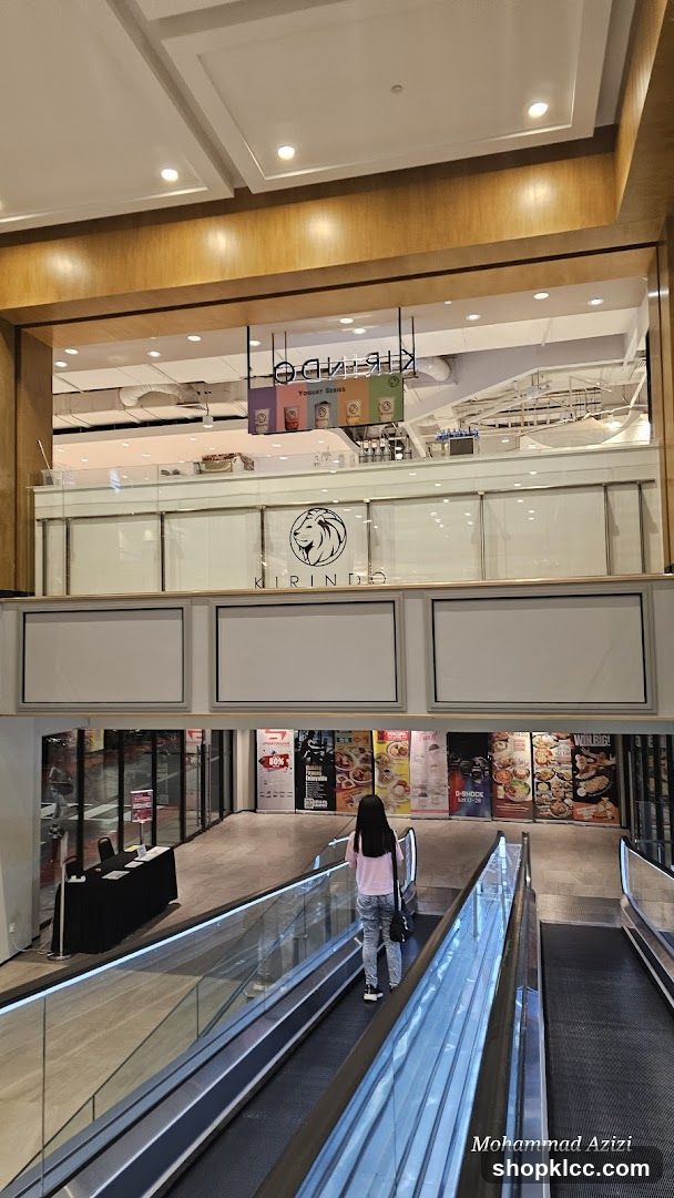 Shopping Mall Interior with Escalator and Storefronts