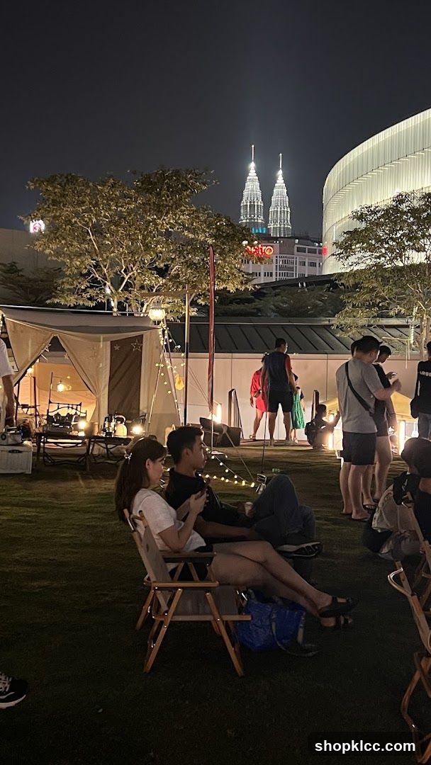Night Outdoor Gathering with Petronas Twin Towers in Background