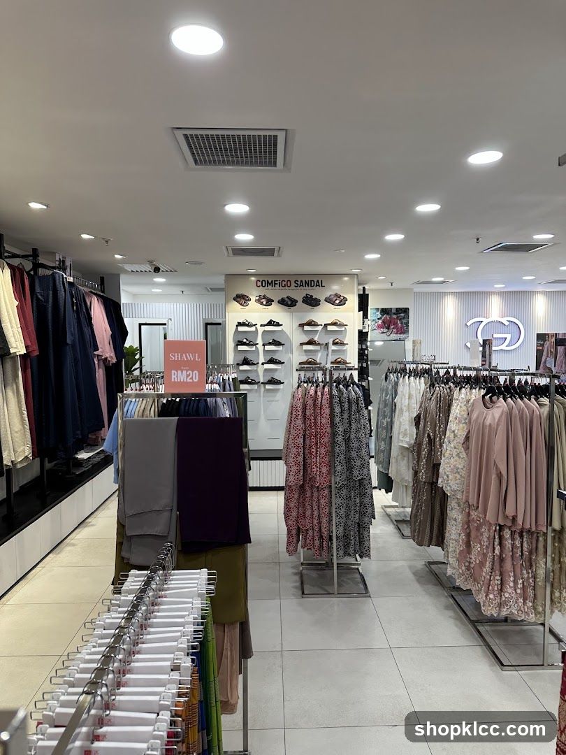 Clothing store interior with racks of apparel and footwear display.