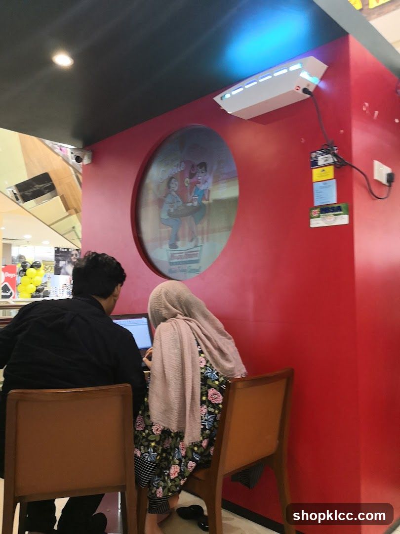 People using a laptop at a counter