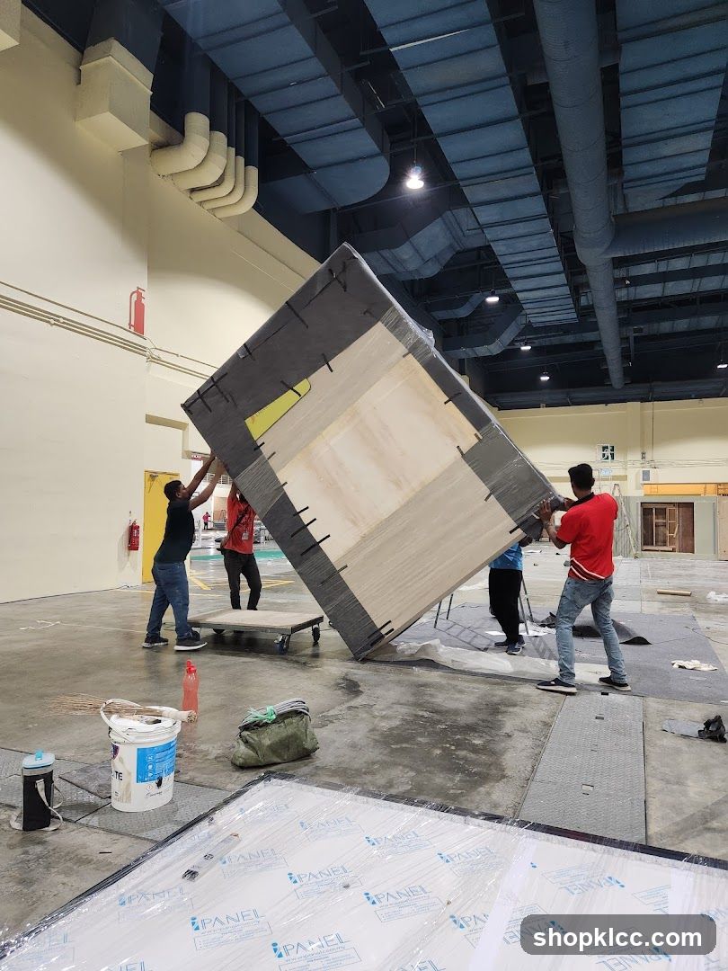 Construction workers moving a large panel