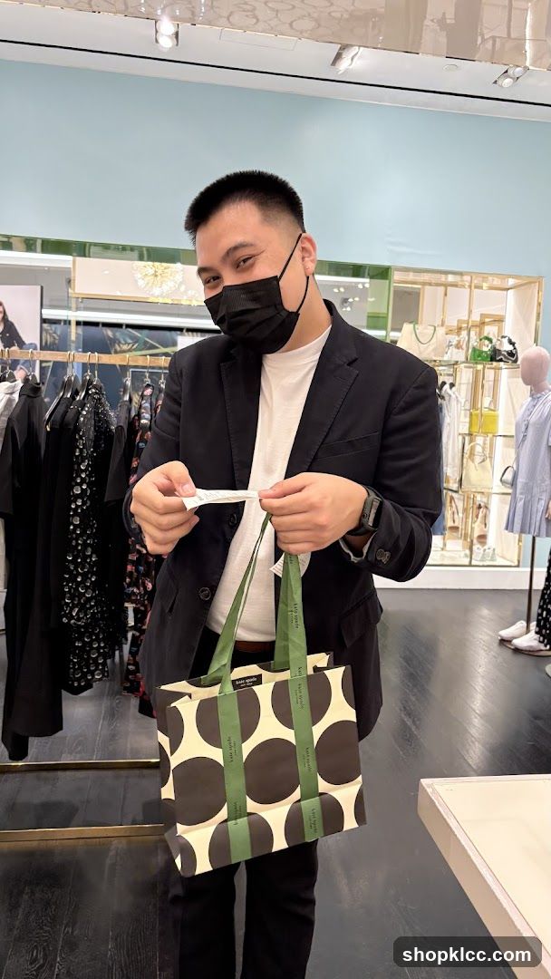 Man holding a shopping bag and receipt