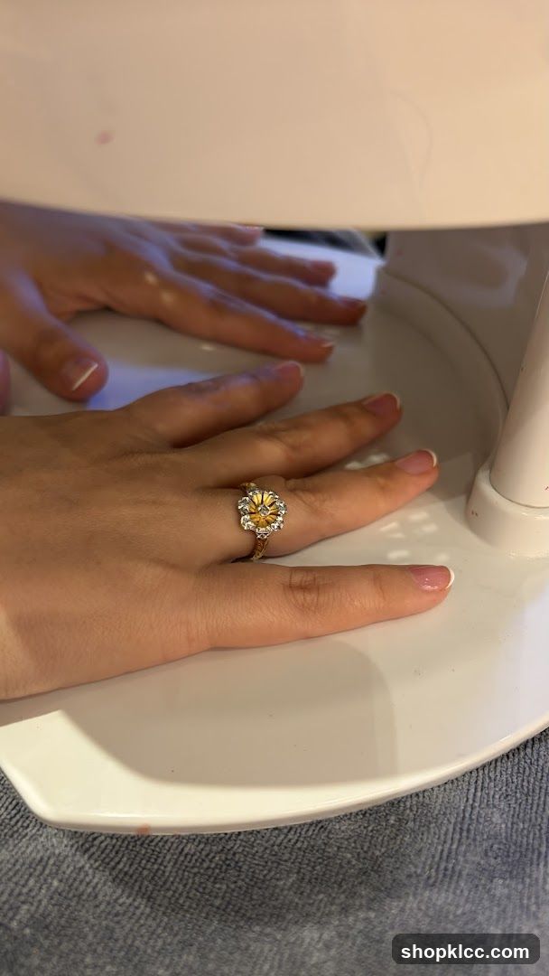 Hands under a UV nail lamp
