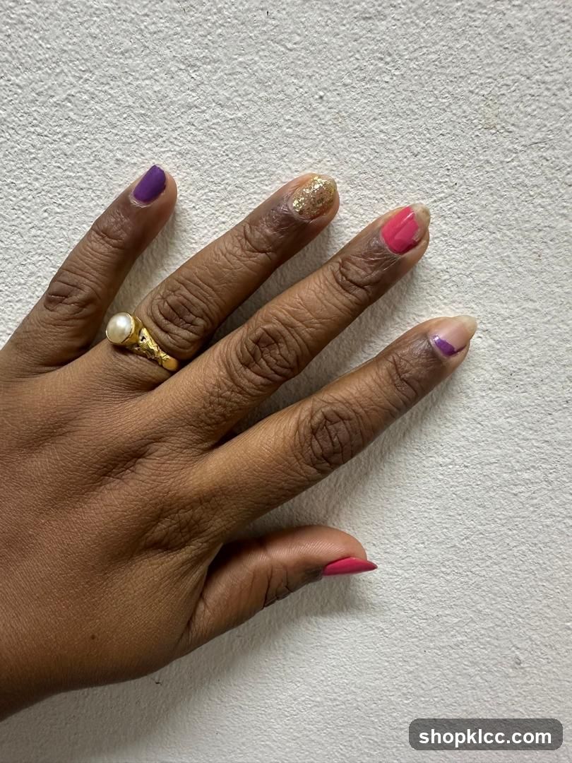 Hand with colorful nail polish and a ring