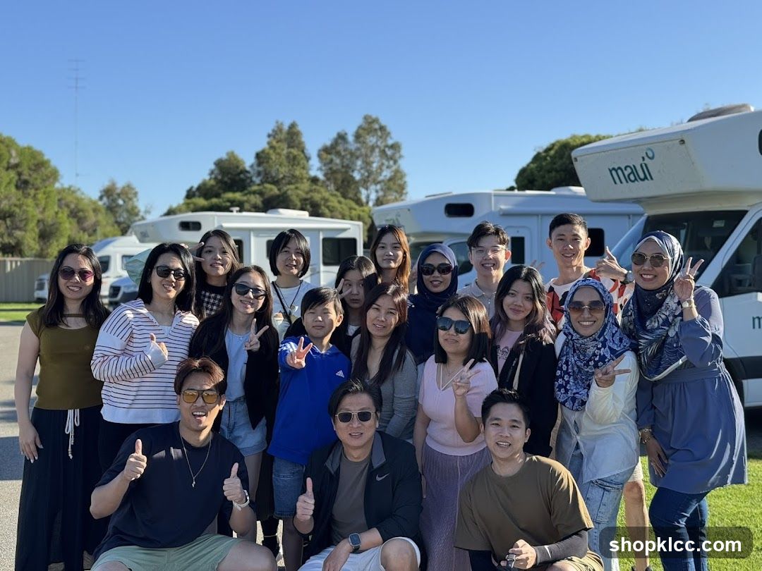 Group of people posing in front of RVs
