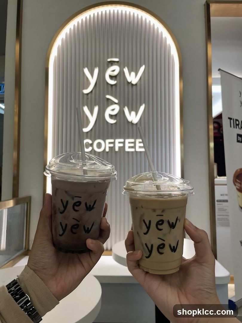 Two iced coffee drinks with the shop's logo