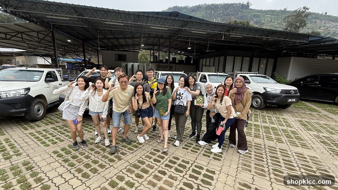 Group posing for a photo with vehicles