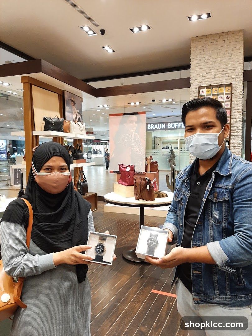 People holding watches in a store