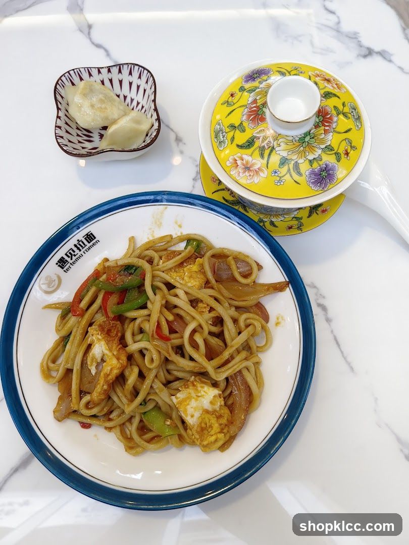 Stir-fried noodles with dumplings and tea