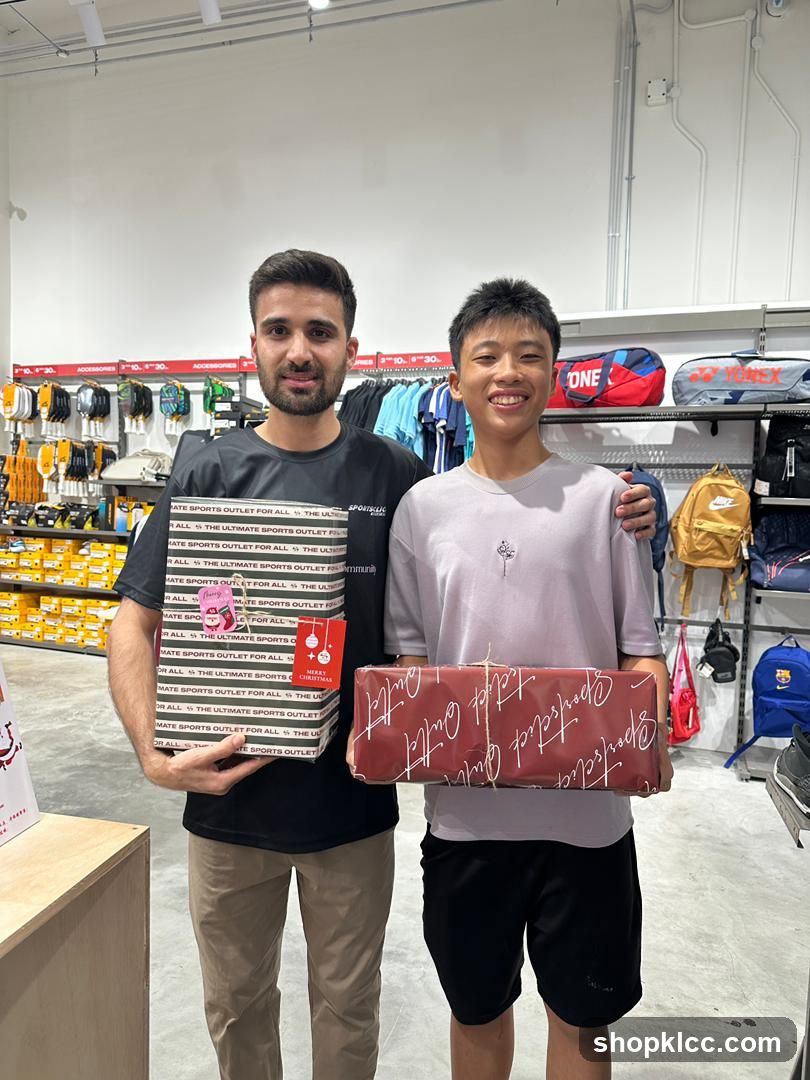 Two people holding gifts in a sports store