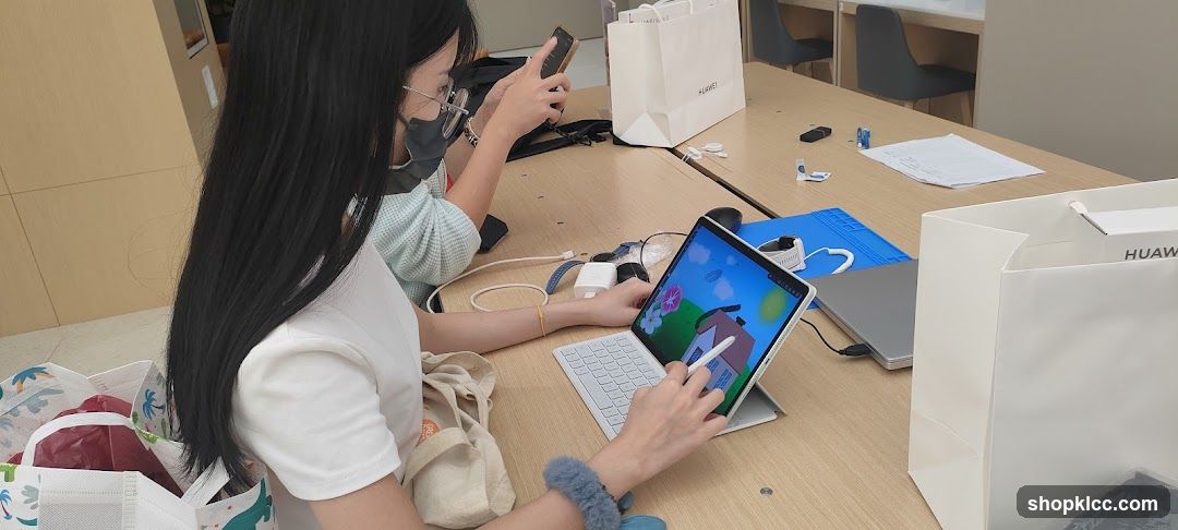 People using devices at a table