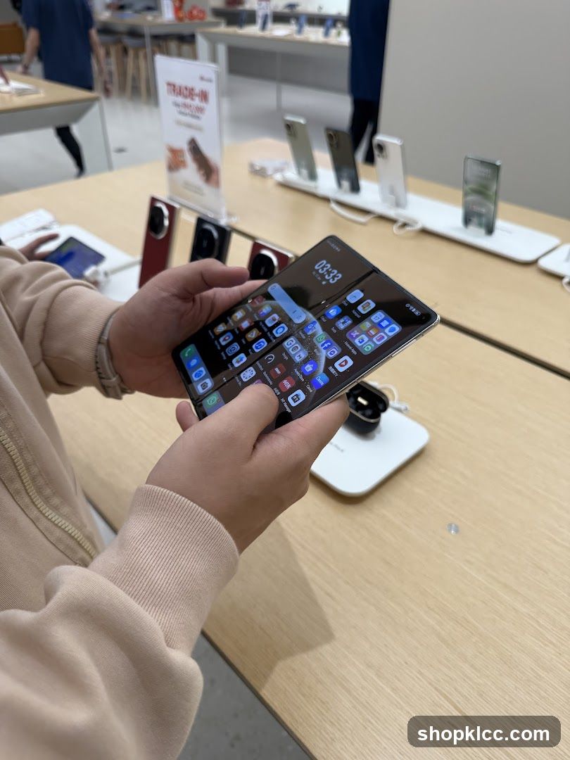 Person holding a foldable smartphone in a store