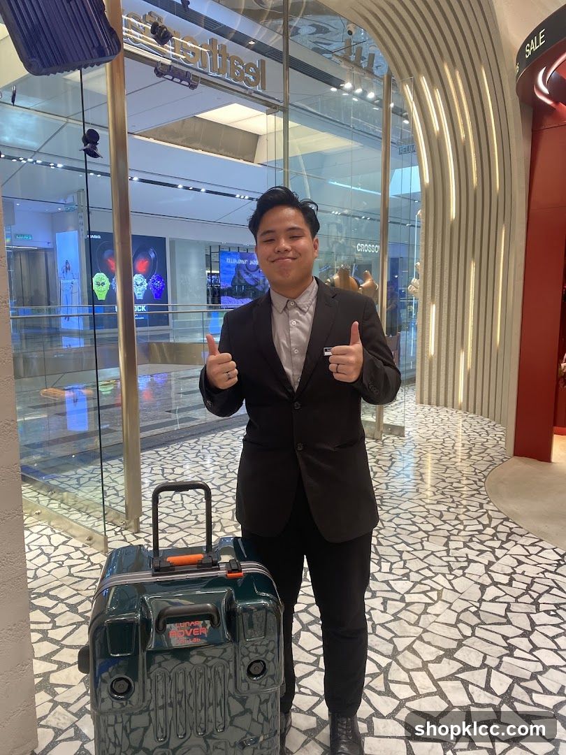 Man with Suitcase Giving Thumbs Up