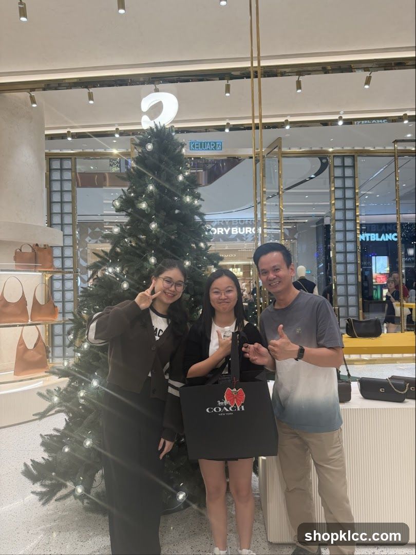 Family Poses in Front of Christmas Tree and Coach Bag
