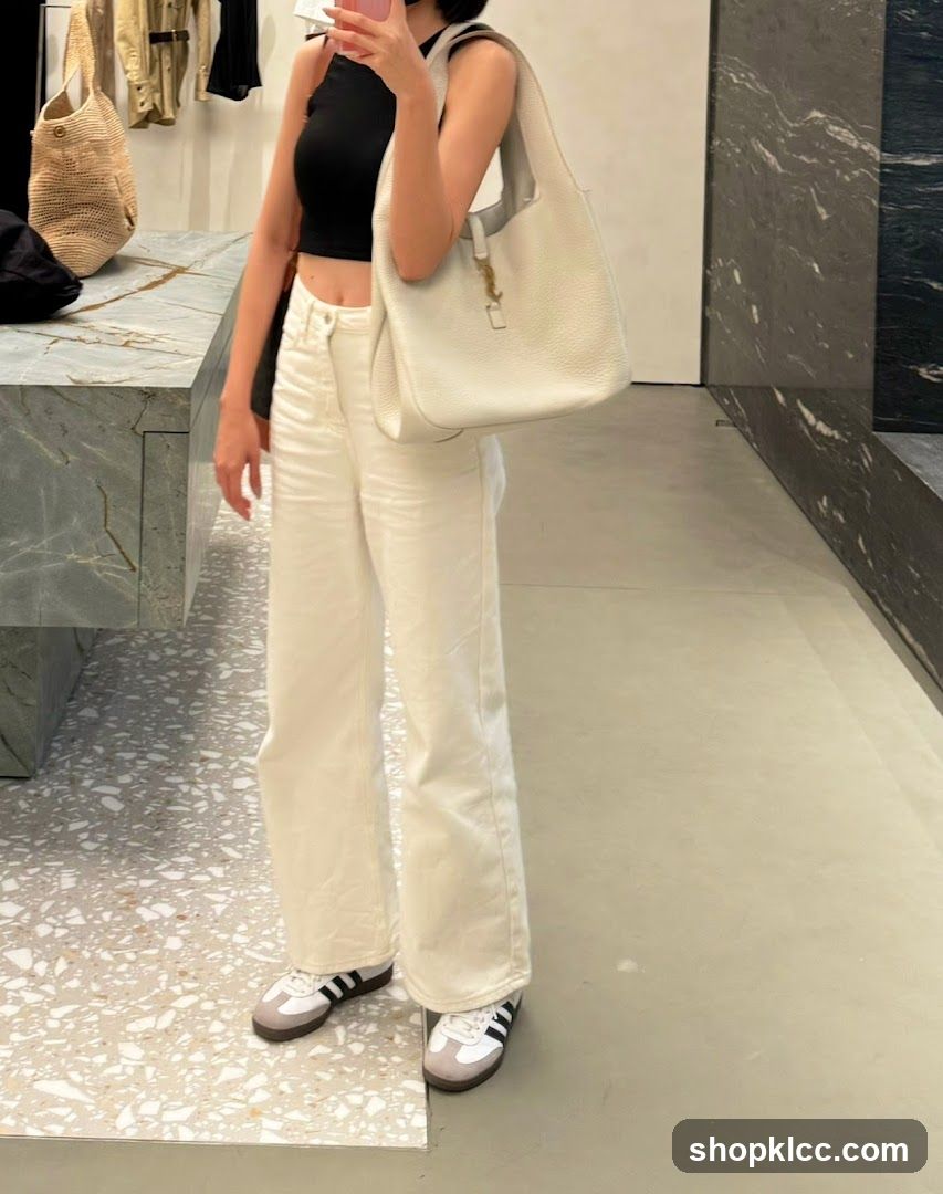 Woman in white outfit with a white handbag