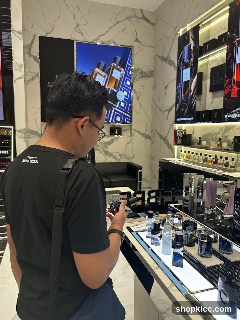 Man examining perfume bottles in a store