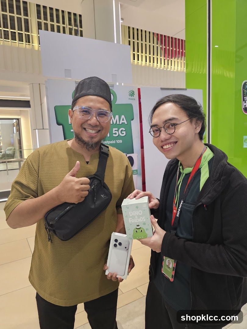 Two men holding a phone and a box