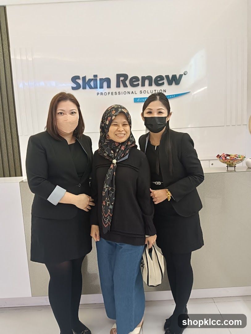 Three women posing in front of a sign