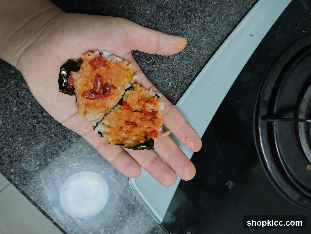 Hand holding rice and seaweed mixture