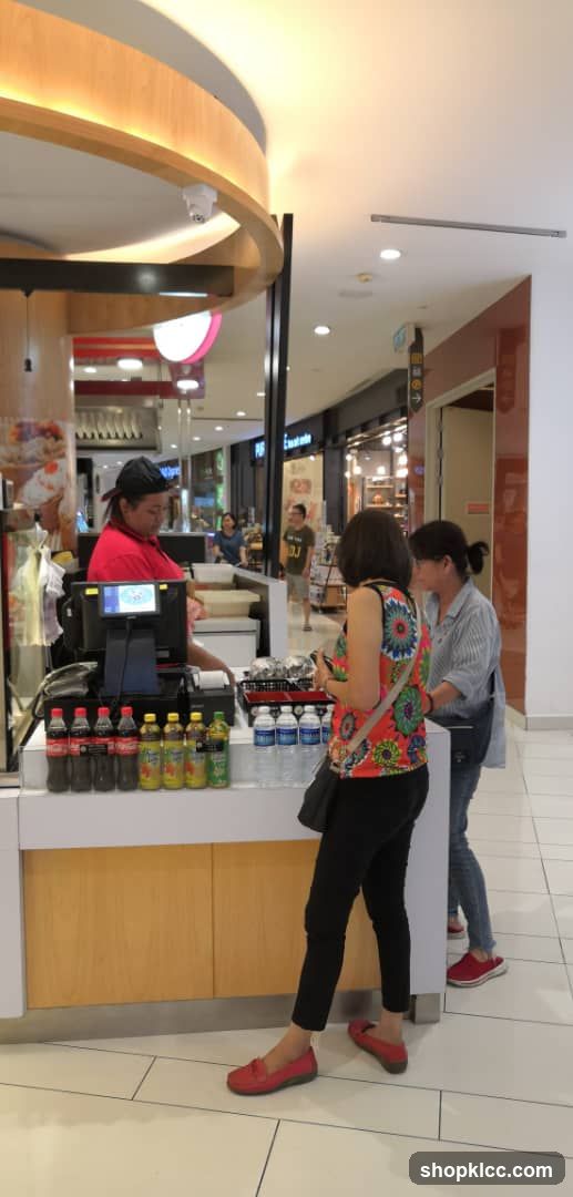 Customers at a food kiosk