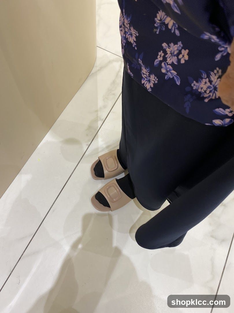 Person wearing sandals and black clothing