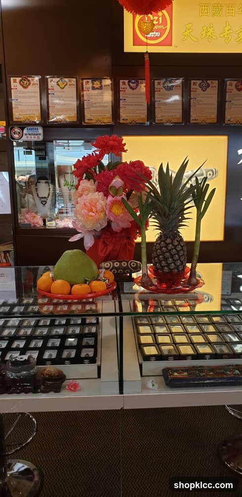 Jewelry store display with auspicious fruits and flowers