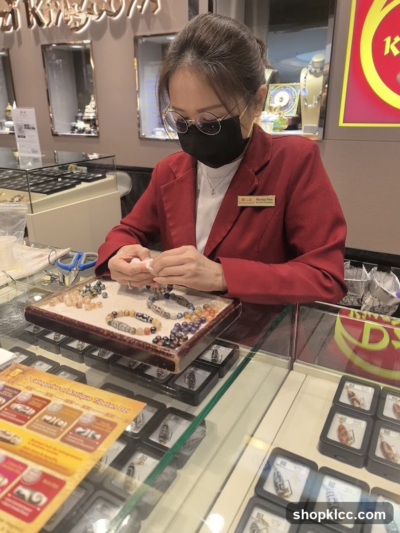 Jewelry store employee working with beads
