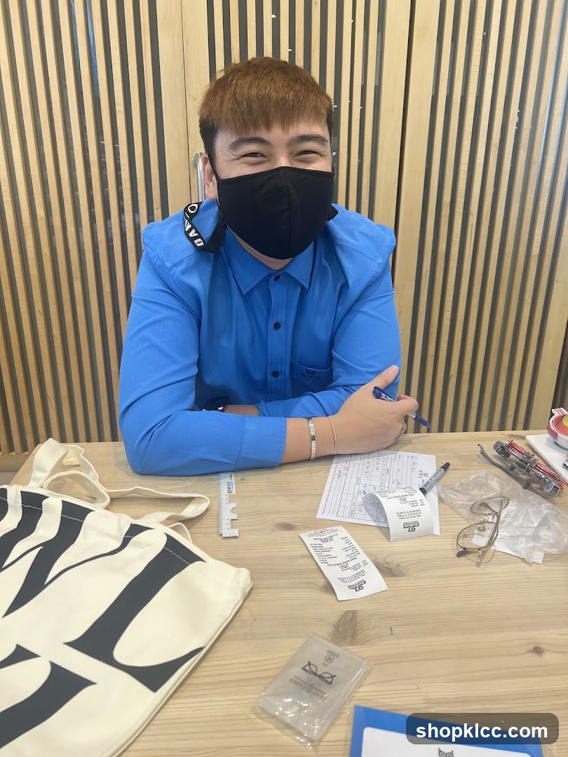 Man at a desk with a tote bag and receipts