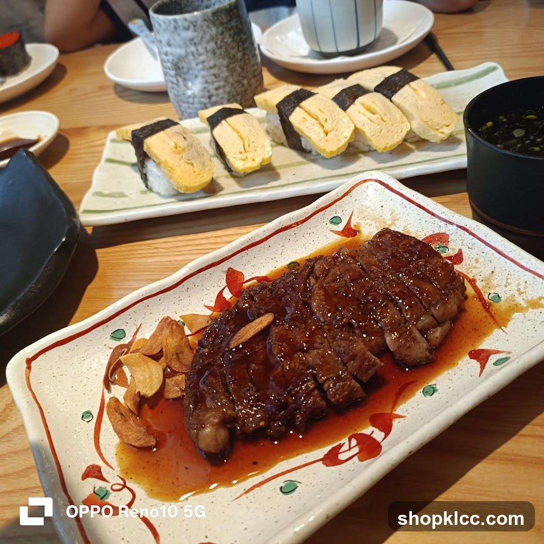Sliced steak and sushi on a table