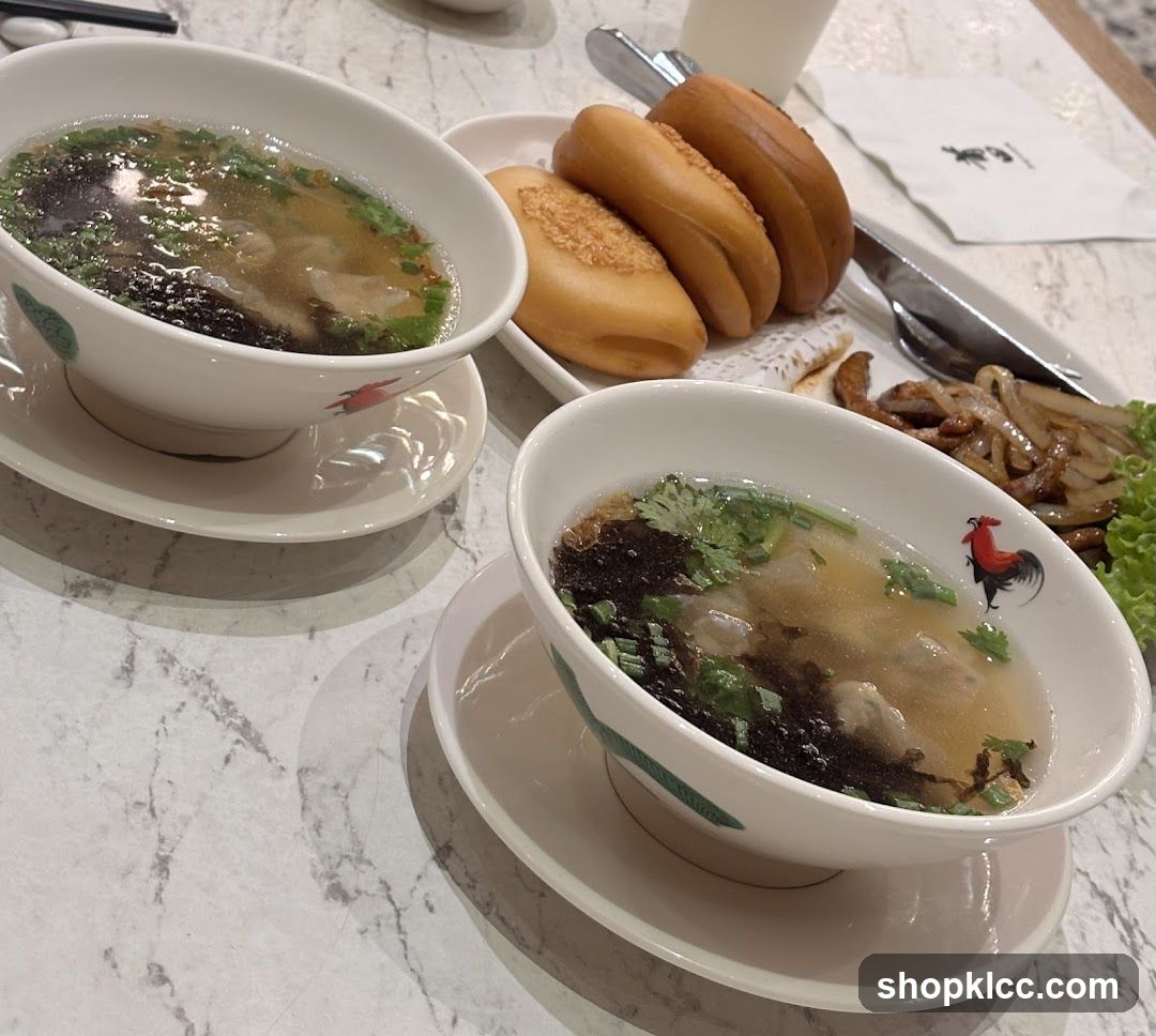 Two bowls of soup with fried buns