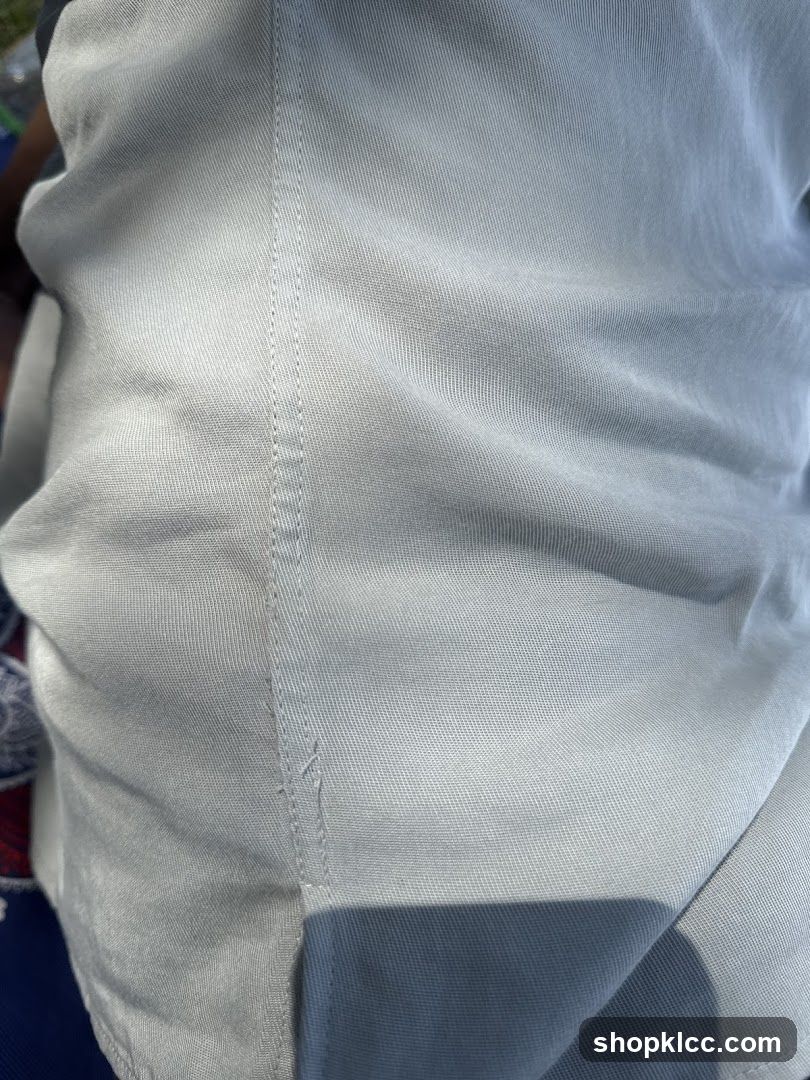 Close-up of light-colored fabric with stitching