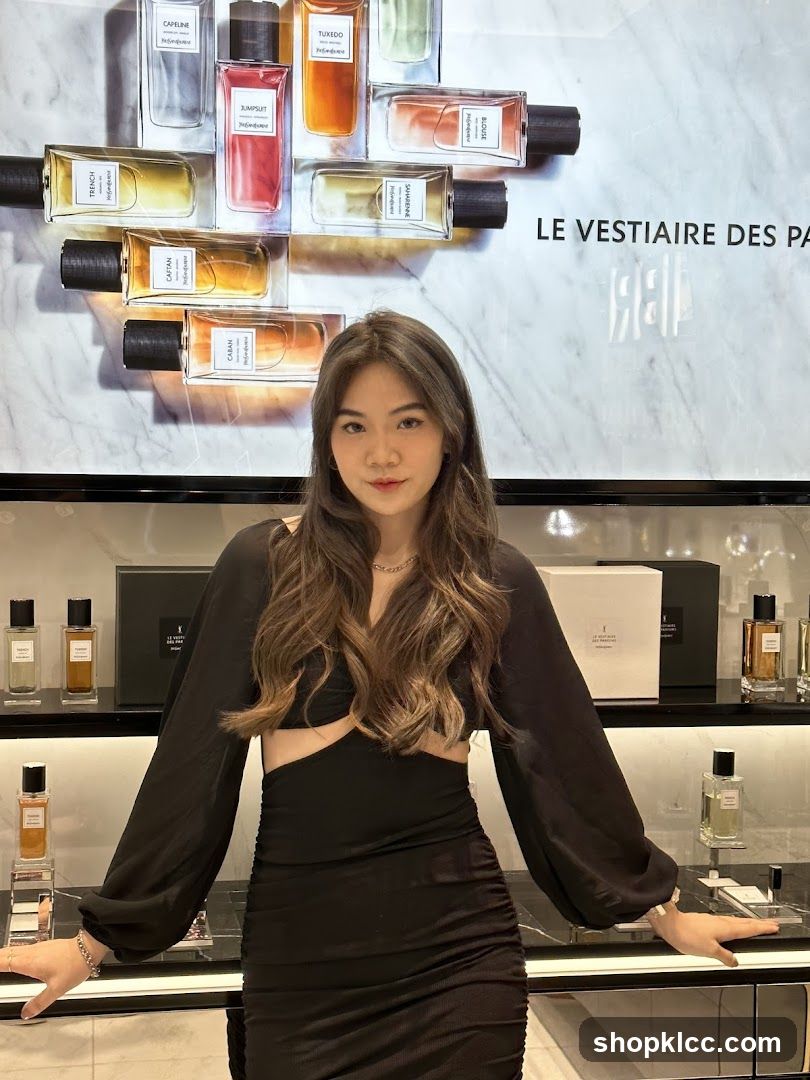 Woman Posing in Front of Perfume Display