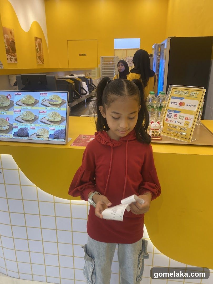 Child at counter in bright yellow store