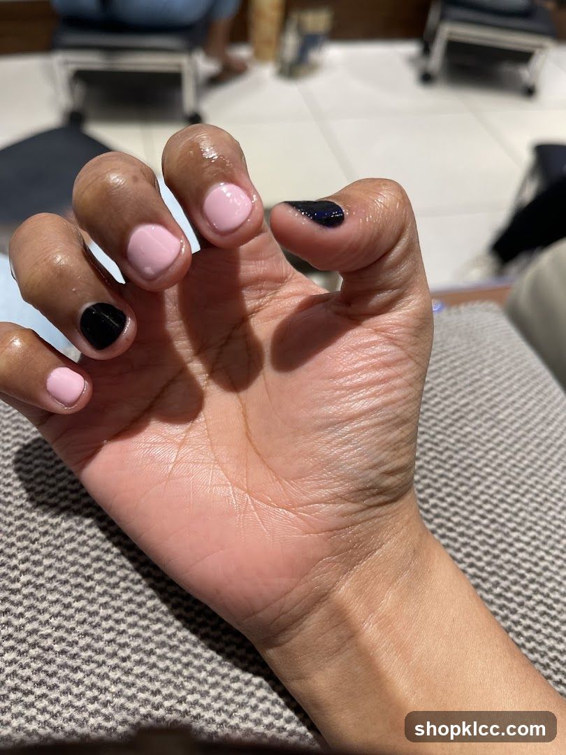 Manicured Hand with Pink and Black Polish